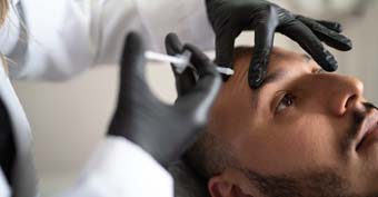 Patient about to undergo cosmetic surgery by doctor