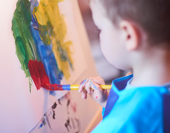 Child painting a water painting