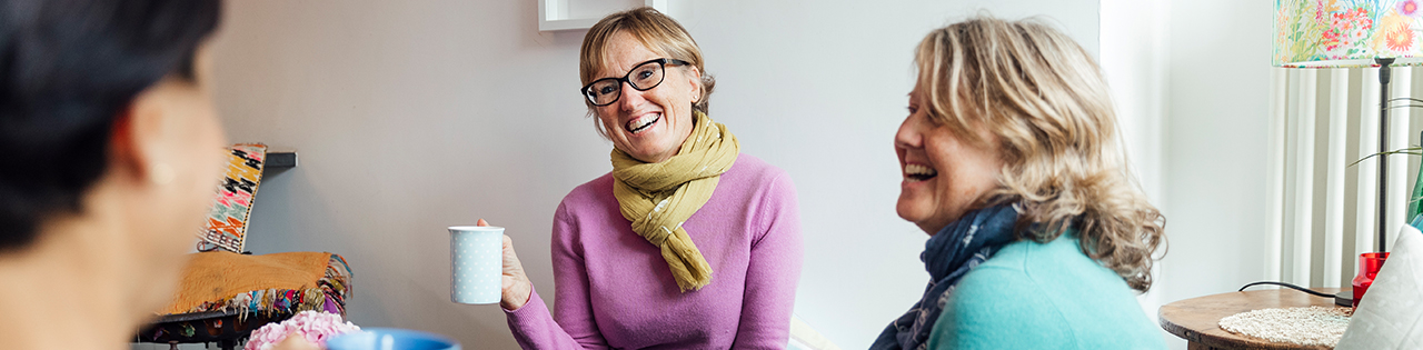 Three friends drinking tea in the living room