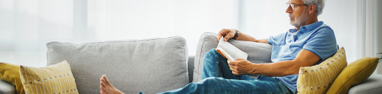 Man sitting on the sofa reading a book