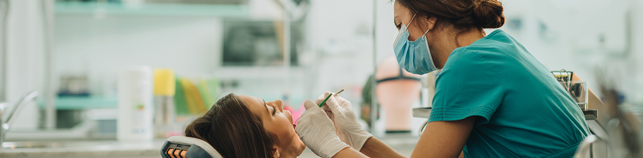 Dentist checking the teeth of a patient at a dental practice