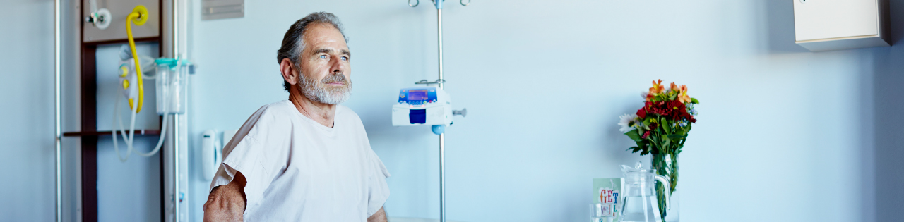 Patient sitting no bed in hospital ward