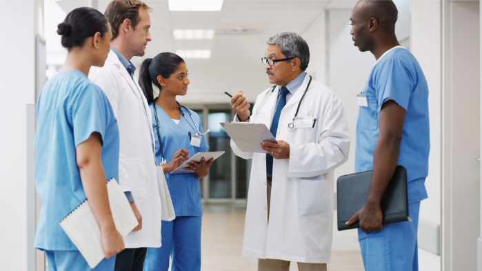 Senior doctor talking to other doctors and nurses in a hospital