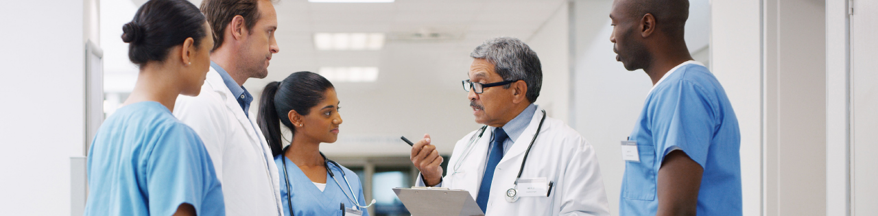 Senior doctor talking to other doctors and nurses in a hospital