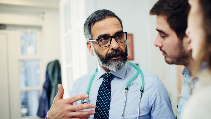 Locum doctor talking to patients in a hospital