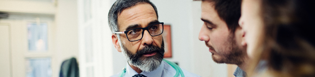 Locum doctor talking to patients in a hospital