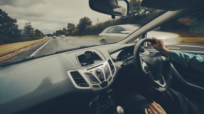person driving car on road