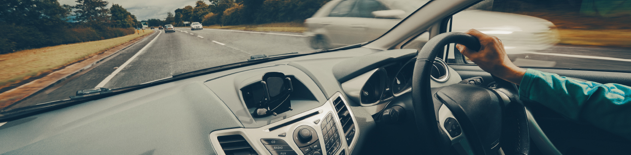 person driving car on road