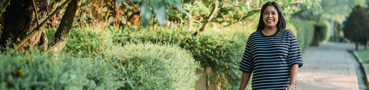 Person walking on an outdoor path in a garden having previously suffered from personal injury