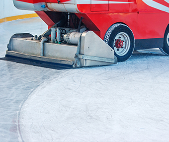 Machine cleaning the ice on an ice rink