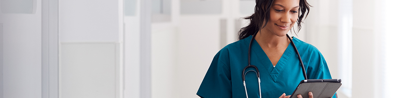 Medical doctor at work in a hospital looking at a tablet screen