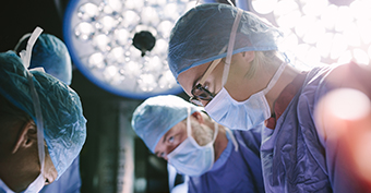 Surgeons performing a surgery on a patient in a hospital