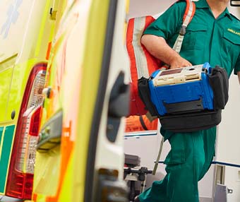 Paramedic on dutry walking out of an ambulance