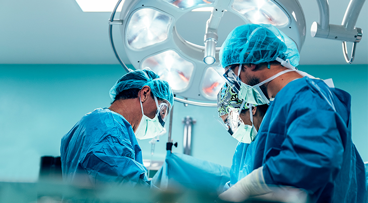 Doctors performing surgery on patient at hospital