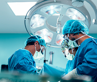Doctors performing surgery on patient at hospital