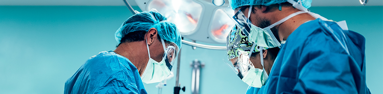 Doctors performing surgery on patient at hospital