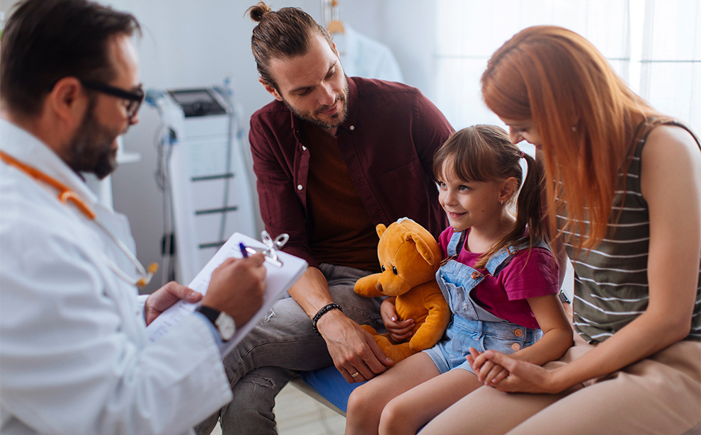 A doctor discussing a child's health with their family, providing medical advice and support.