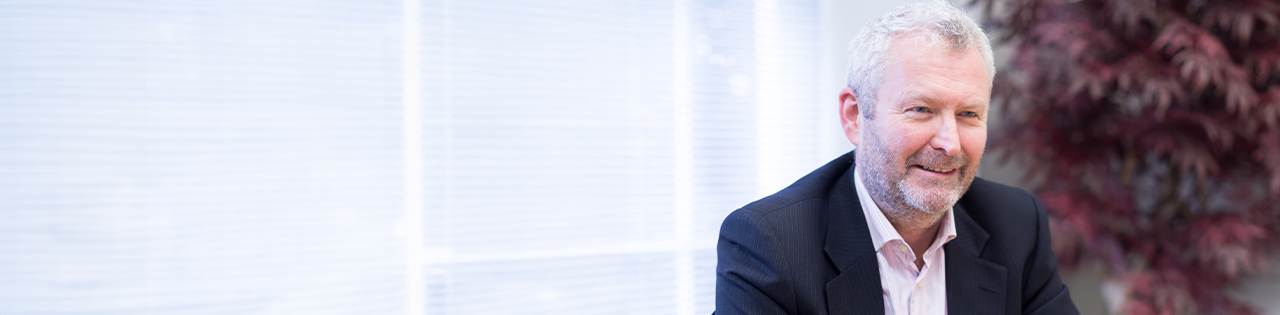 Man sat at table in a suit