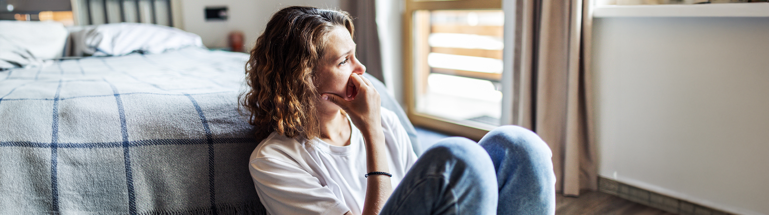 person sat on floor looking upset
