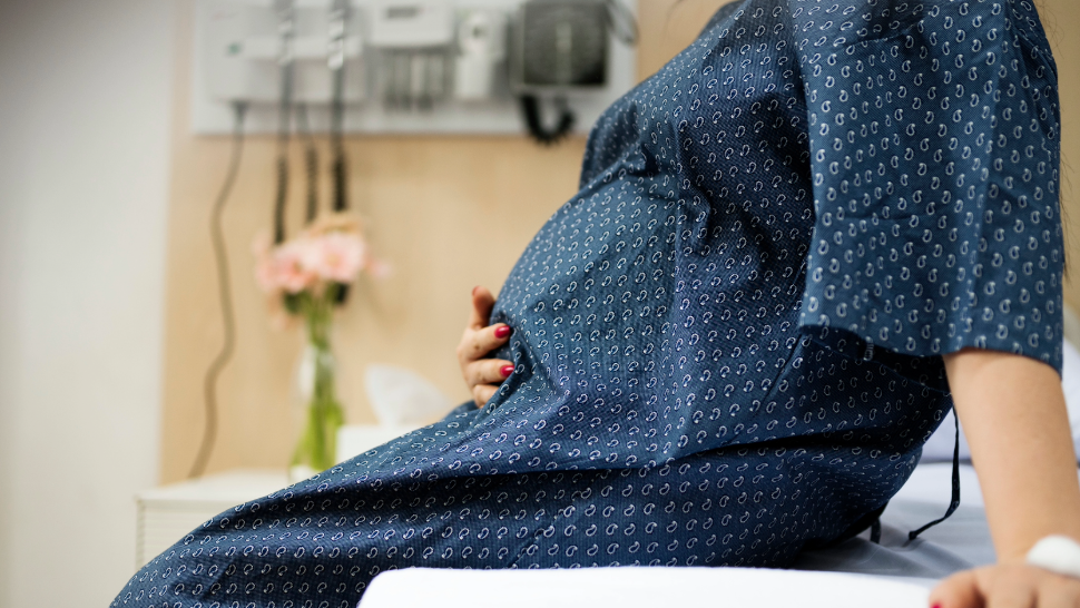 A pregnant woman holding her belly